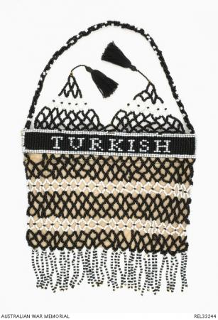 Turkish loom and netting beaded purse. On one side of the purse, the loom work reads “TURKISH”, on the other is “PRISONERS".