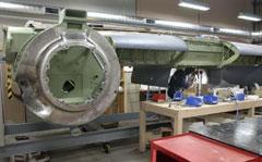 Airframe fitter Jamie Croker fitting the bomb bay side walls to the centre wing section